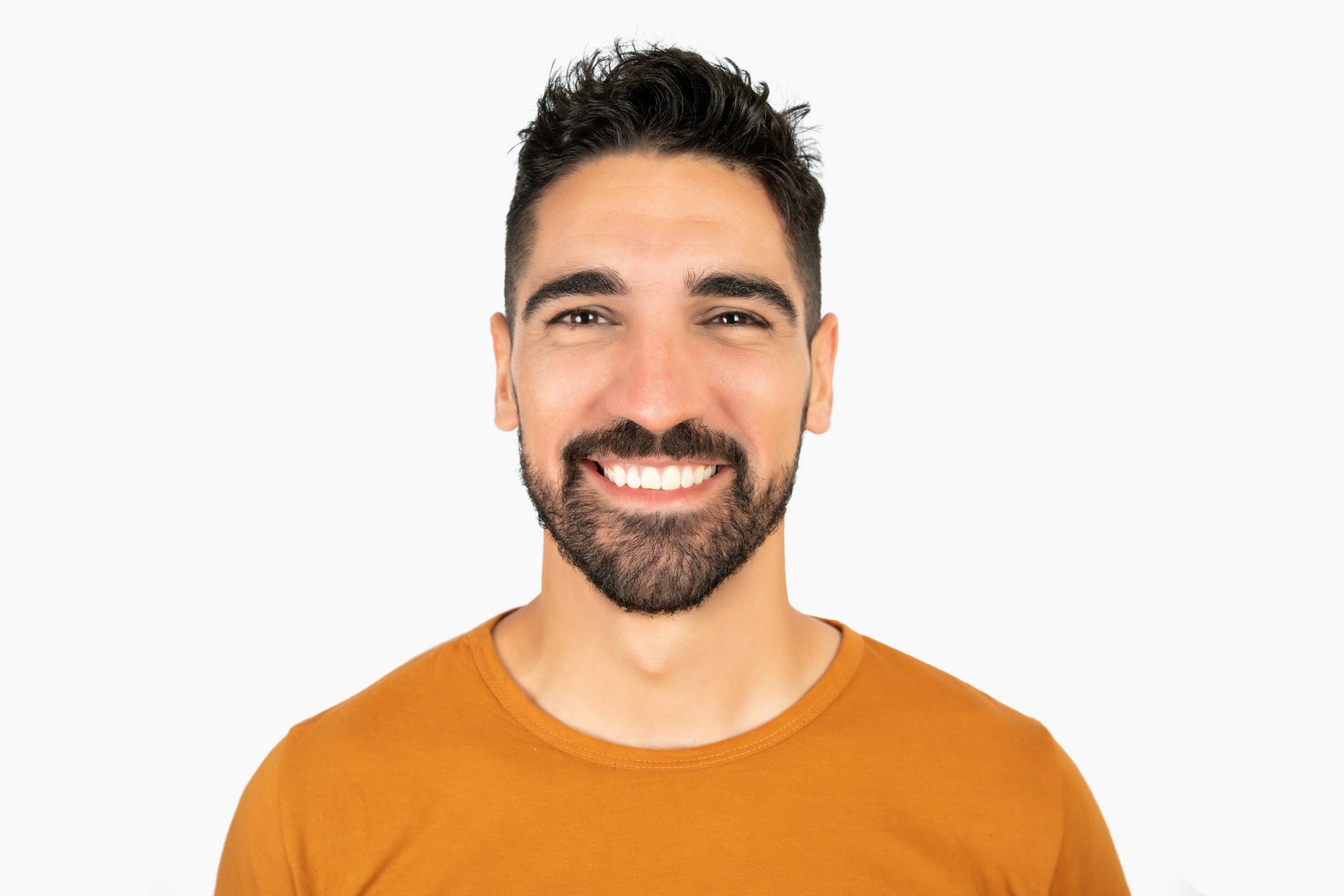 Young man smiling against white background.